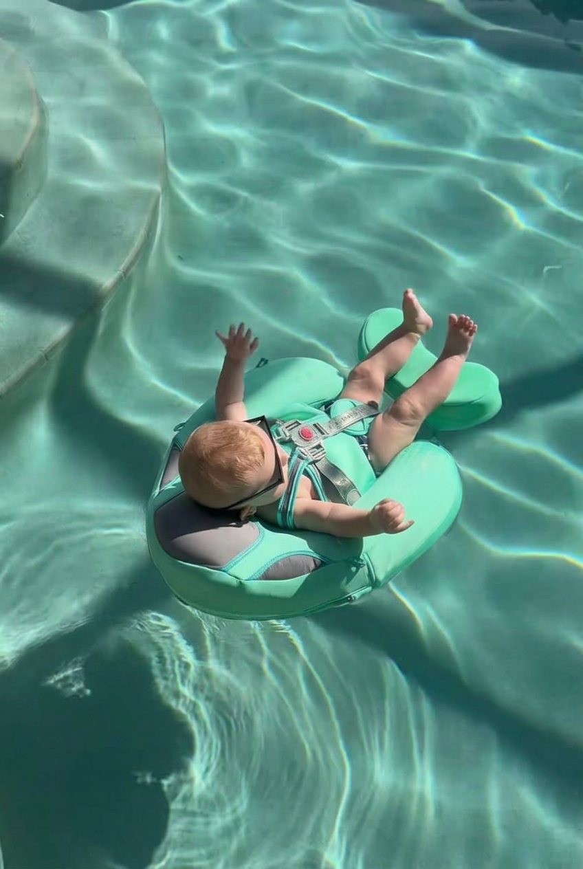 Baby floating calmly in the mint AquaNest float