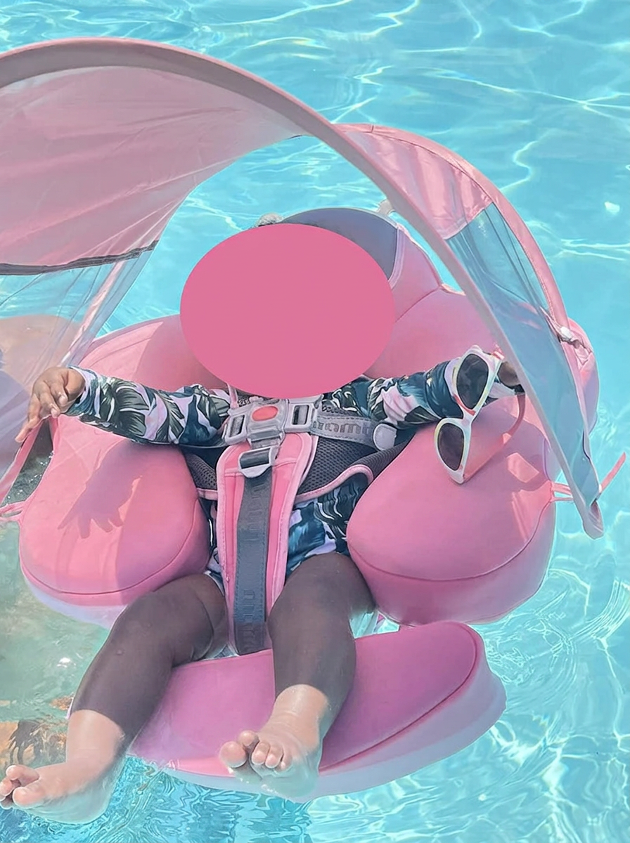Toddler in the blush AquaNest float with canopy shade