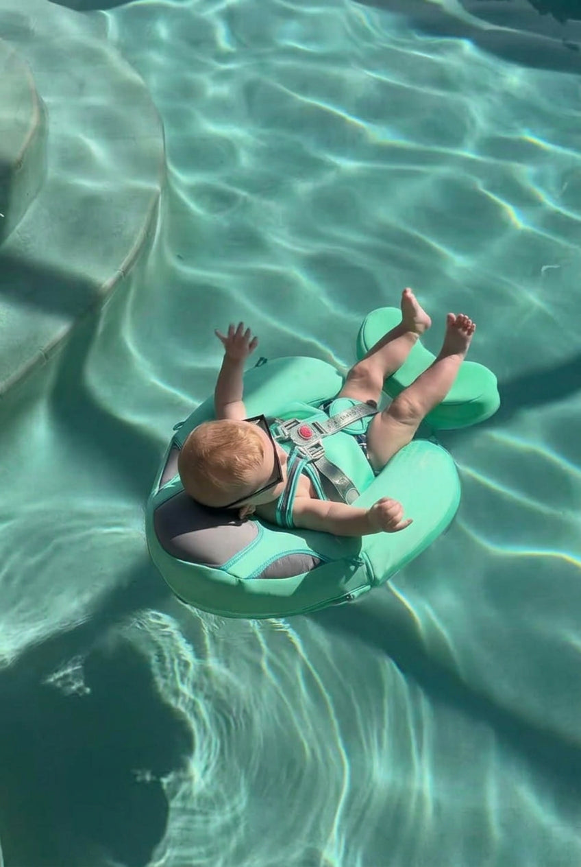Baby floating calmly in the mint AquaNest float